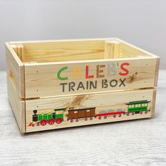 a wooden box that says cales train box on the front and sides with trains painted on it