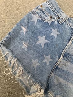 a pair of ripped shorts with stars painted on them