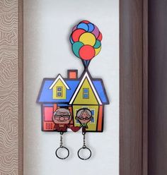 an image of two people holding balloons in front of a house with a balloon attached to it