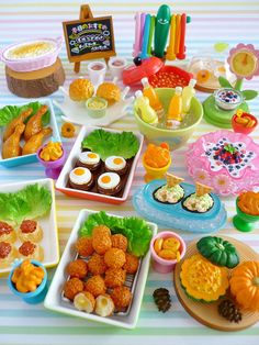 a table topped with lots of food and plates filled with different types of foods on top of it