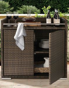 a wicker bar with plates and glasses on it