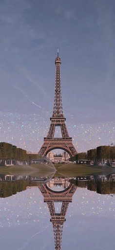 the eiffel tower is reflected in water