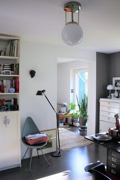 a living room filled with furniture and a lamp