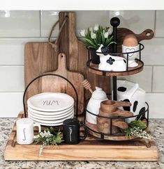 a kitchen counter with plates and utensils on it, including a cutting board