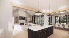 a large open concept kitchen and living room with wood flooring, white walls and black cabinets