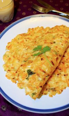 two cheesy flatbreads on a plate next to a glass of milk