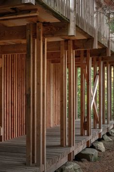 a wooden structure with stairs and railings in the woods