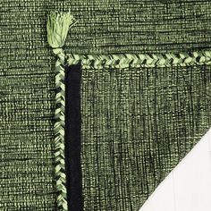 a close up of a piece of cloth with a green and black design on it