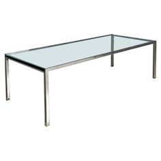 a glass table with metal legs on a white background