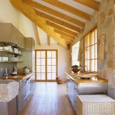 a kitchen with wood floors and stone walls is pictured in this image from the inside