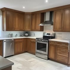 a kitchen with wooden cabinets and stainless steel appliances