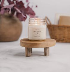 a candle sitting on top of a wooden stool