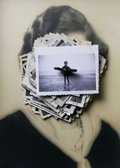 a man with a surfboard in his hand is surrounded by many photos and papers