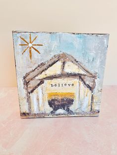 a painting with the word believe on it and a barn in the background that says believe