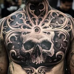 a man with a skull tattoo on his chest