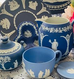 blue and white porcelain items displayed on lace tablecloth