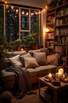 a living room filled with lots of furniture and bookshelves next to a window