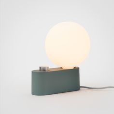 a light that is sitting on top of a metal box with a cord attached to it