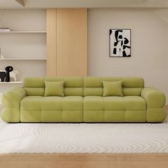 a living room with a green couch and white rug