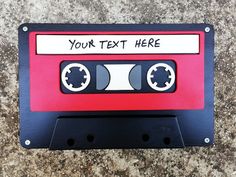 a red and black cassette tape with the words your text here on it is attached to a wall