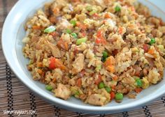 a white bowl filled with food on top of a table