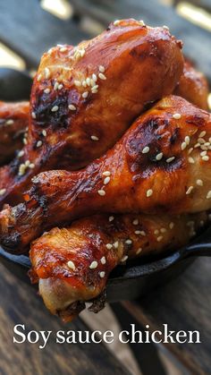 chicken wings with sesame seeds in a cast iron skillet on a wooden table top