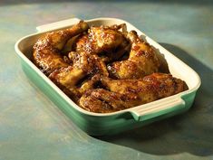 a green and white container filled with chicken wings