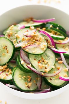 cucumber and onion salad in a white bowl