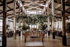 the inside of a large building with tables and chairs set up for a formal function