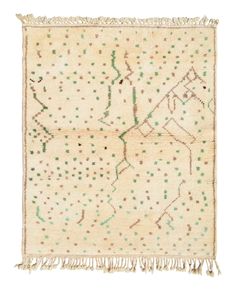 an old rug with green dots and fringes