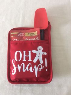 a red pouch with a toothbrush, spoon and other items inside that says oh snap