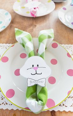 a bunny napkin holder sitting on top of a white and green polka dot table cloth