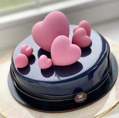 there is a cake with pink hearts on it