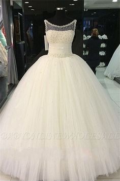 a white wedding dress on display in a store