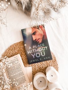 a book sitting on top of a table next to some candles and other items in front of it