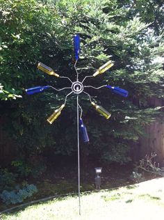 a blue and yellow wind chime is in the yard