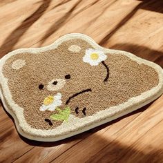 a brown teddy bear rug sitting on top of a wooden floor