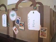 a brown paper bag with tags attached to it and some stickers on the handles