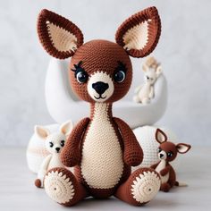 a crocheted stuffed animal sitting next to other stuffed animals