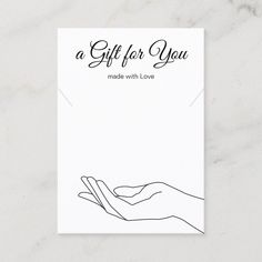 a gift for you made with love card on a marble surface, featuring two hands holding each other