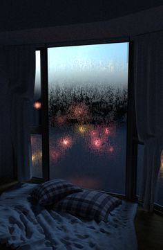 a bed sitting in front of a window covered in raindrops next to a night sky filled with colorful lights