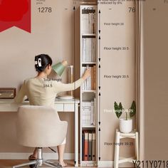 a woman is sitting at a desk with a book shelf and lamp in front of her