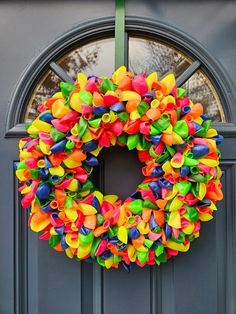 a colorful wreath is hanging on the front door