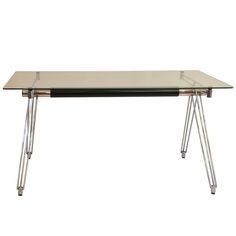 a glass table with metal legs on a white background