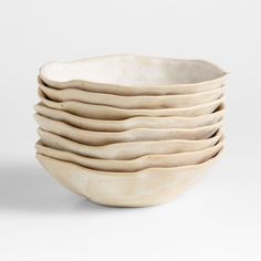 a stack of white bowls sitting on top of each other