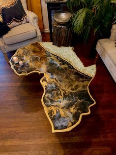 a living room filled with furniture and a table on top of a hard wood floor