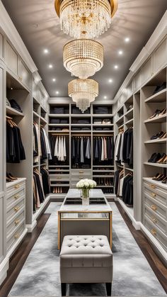 a walk - in closet with chandelier, bench and stool for sitting or lounging