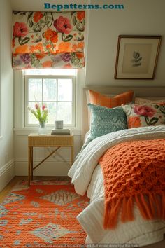 a bedroom with orange and blue decor in the window sill, white bedding, and an orange flowered valance