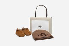 Wrapped in the warmth of UGG®plush, the Tasman is a favorite for all ages. Made from luxurious suede and featuring an easy-to-use hook-and-loop closure, it is paired with a coordinating beanie, ensuring your little one enjoys complete comfort from head to toe. Baby Beanie.Blended Polyester and Nylon knit hat with printed UGG® branding.UGG® Tasman braid accent.Baby Tasman.Suede exterior.UGG® Tasman braid accent.Easy hook-and-loop fastening.10mm UGG®plush, made of 80% repurposed wool and 20% lyoce Baby Uggs, Ugg Slippers, Unisex Accessories, Baby Slippers, Slipper Shoes, Ugg Shoes, Suede Boots, Chestnut, Knitted Hats