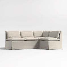 a large sectional couch with pillows on the top and bottom, sitting in front of a white background